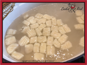 Once they rise to the top, give them 20 seconds and strain from water directly into the serving dish.